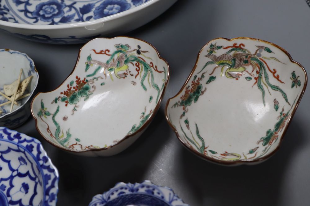 A group of Asian ceramics including a Kangxi blue and white cup and a pair of Chinese enamelled oval scalloped shaped dishes, 26cm (11)